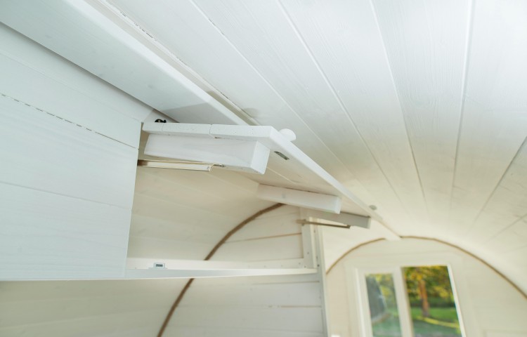 Closed shelve above the bed in Glamping Pod